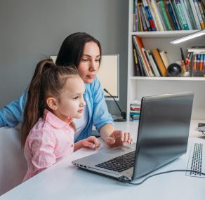 1920-mother-assisting-daughter-with-learning-online